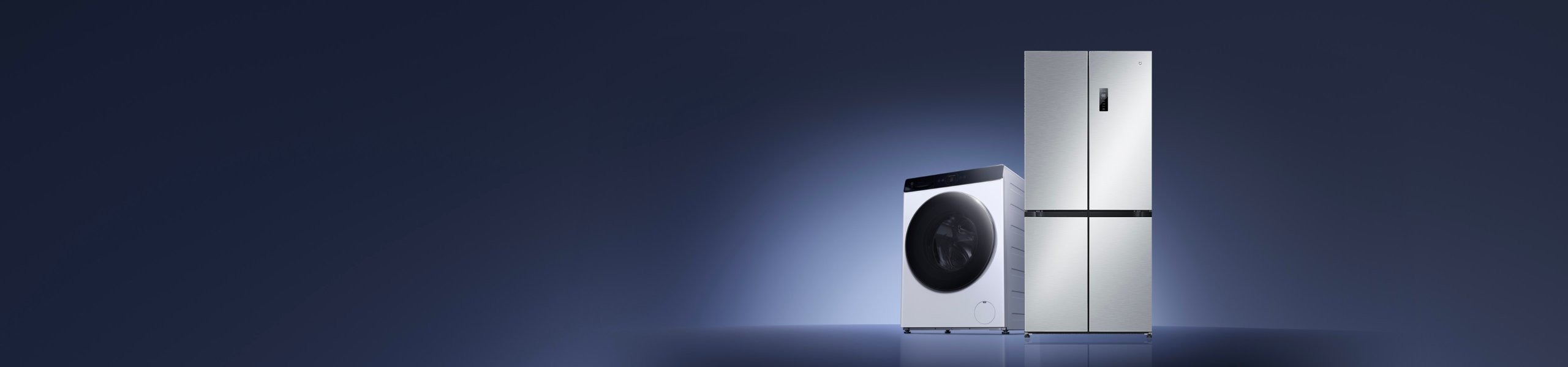 A washing machine and a refrigerator are placed side by side against a dark background. The washing machine is white, and the refrigerator is silver, presenting an overall simple and modern design style.